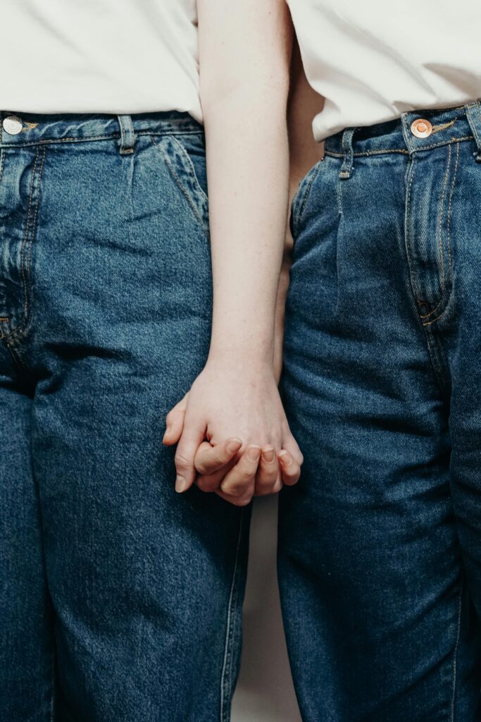 Couple holding hands standing next to each other.