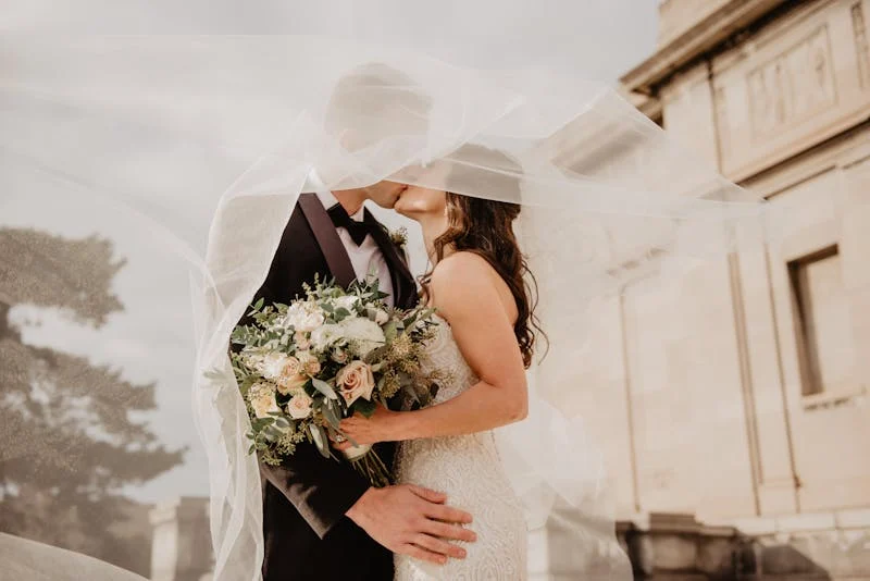 Married couple kissing at their wedding.