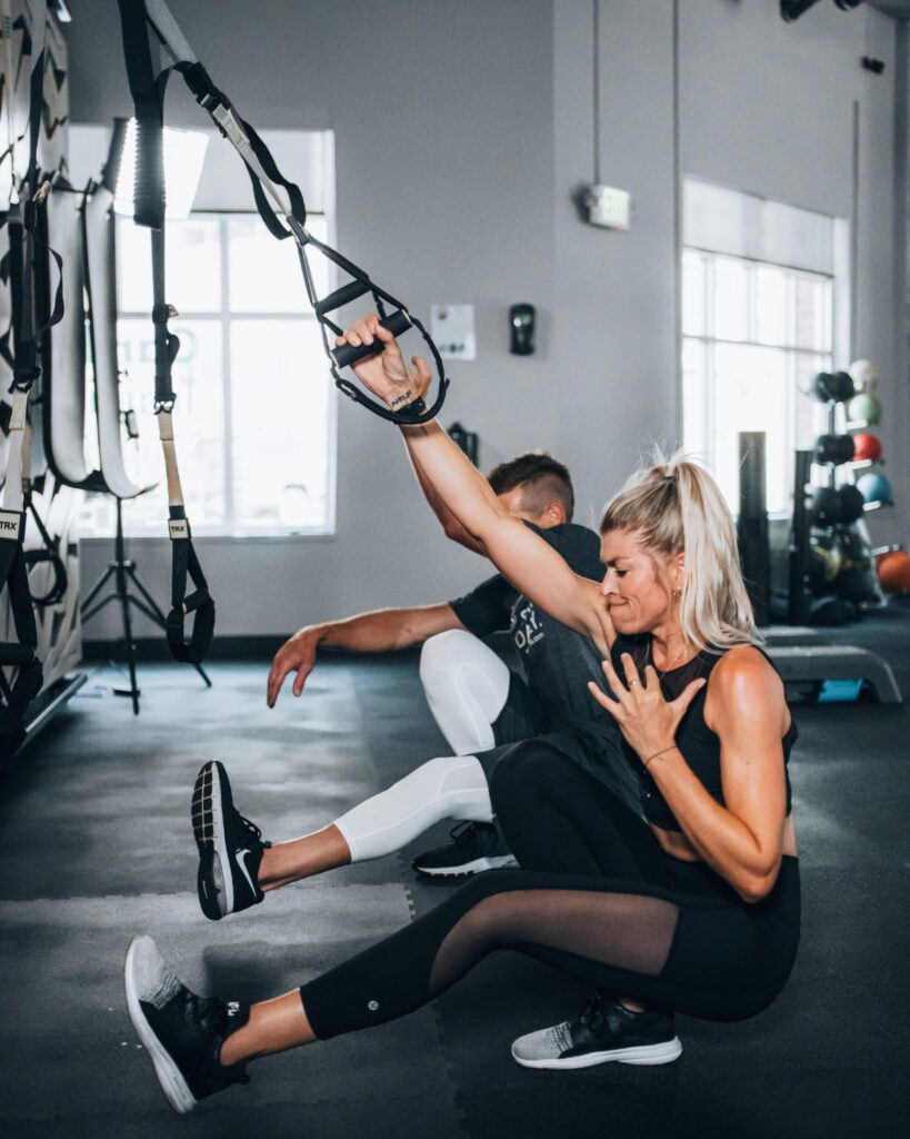 Man and woman working out in the gym together.