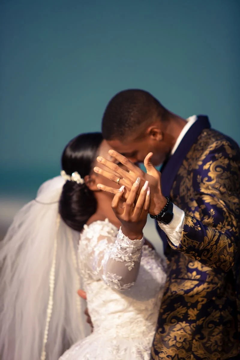 Man and woman kissing, showing wedding band getting married.