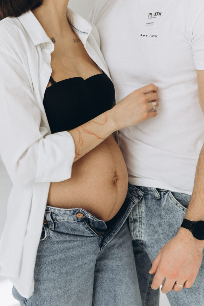 Pregnant couple holding each other.