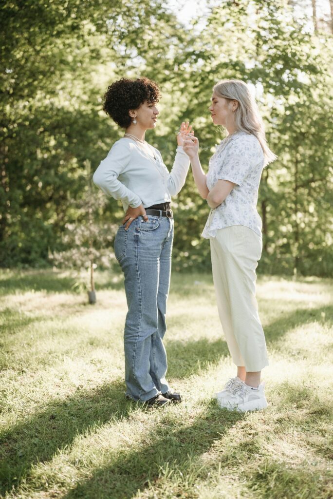 Couple having a conversation outside and holding hands.