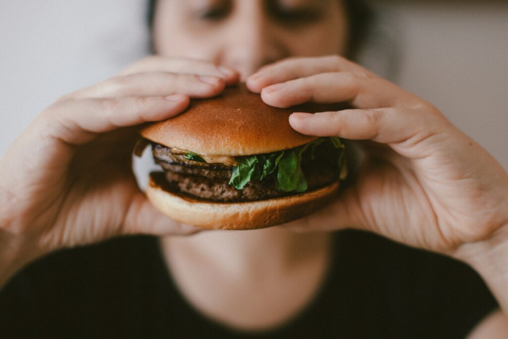 Woman eating a burger.