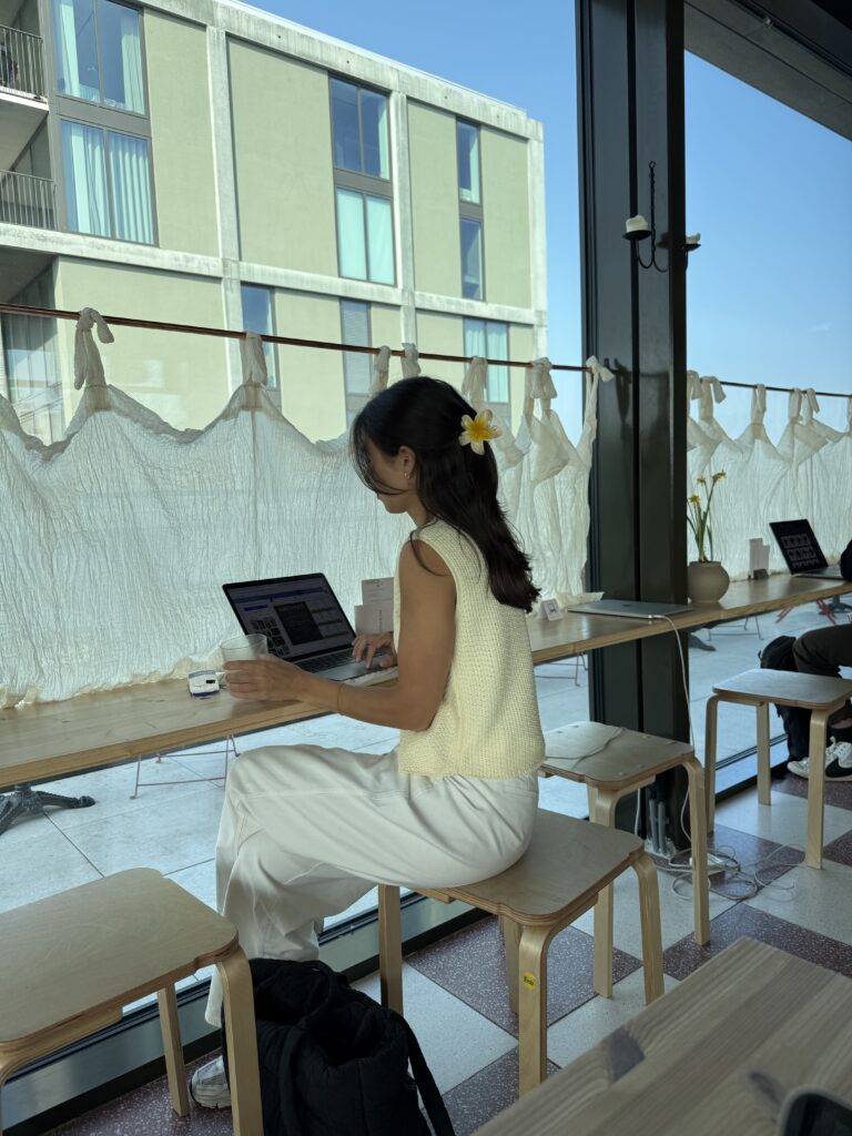 woman working at a cafe on her laptop
