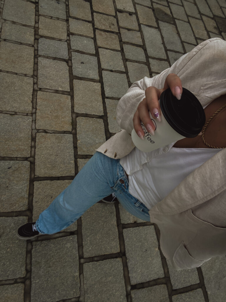 woman walking holding coffee