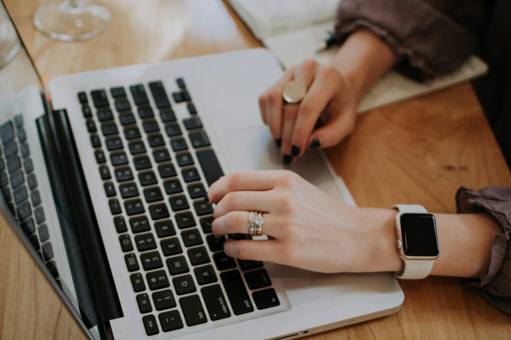 woman working and typing on her computer