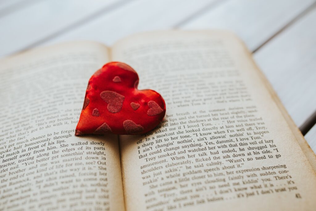 Red heart set on pages of a book.
