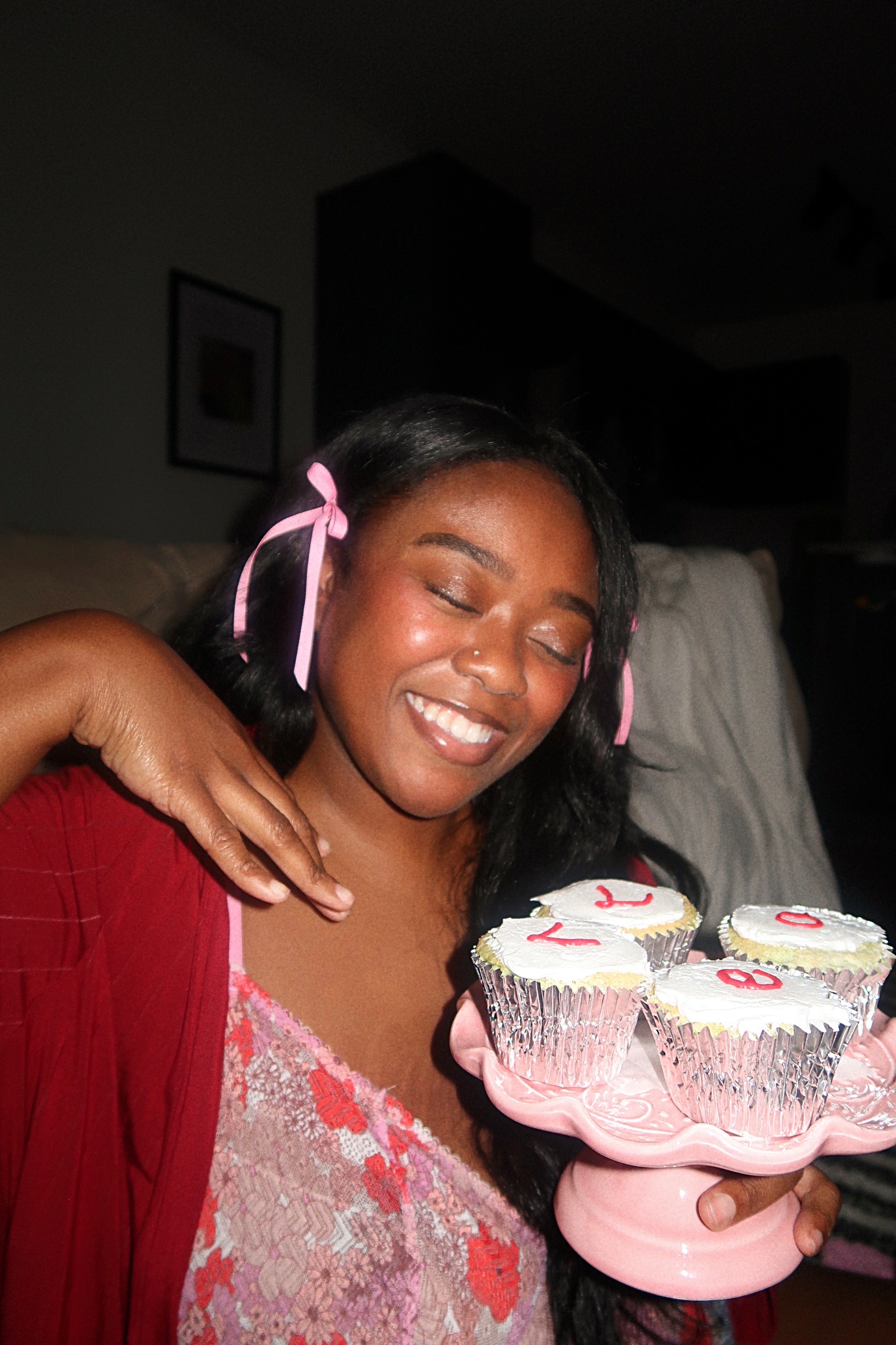 Single woman celebrating Valentine's Day in New York, holding four cupcakes spelled love