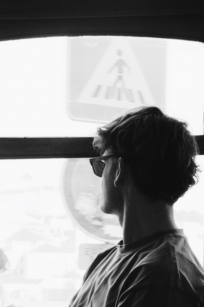 A man overcoming depression, taking a breath and looking out the window in Manhattan