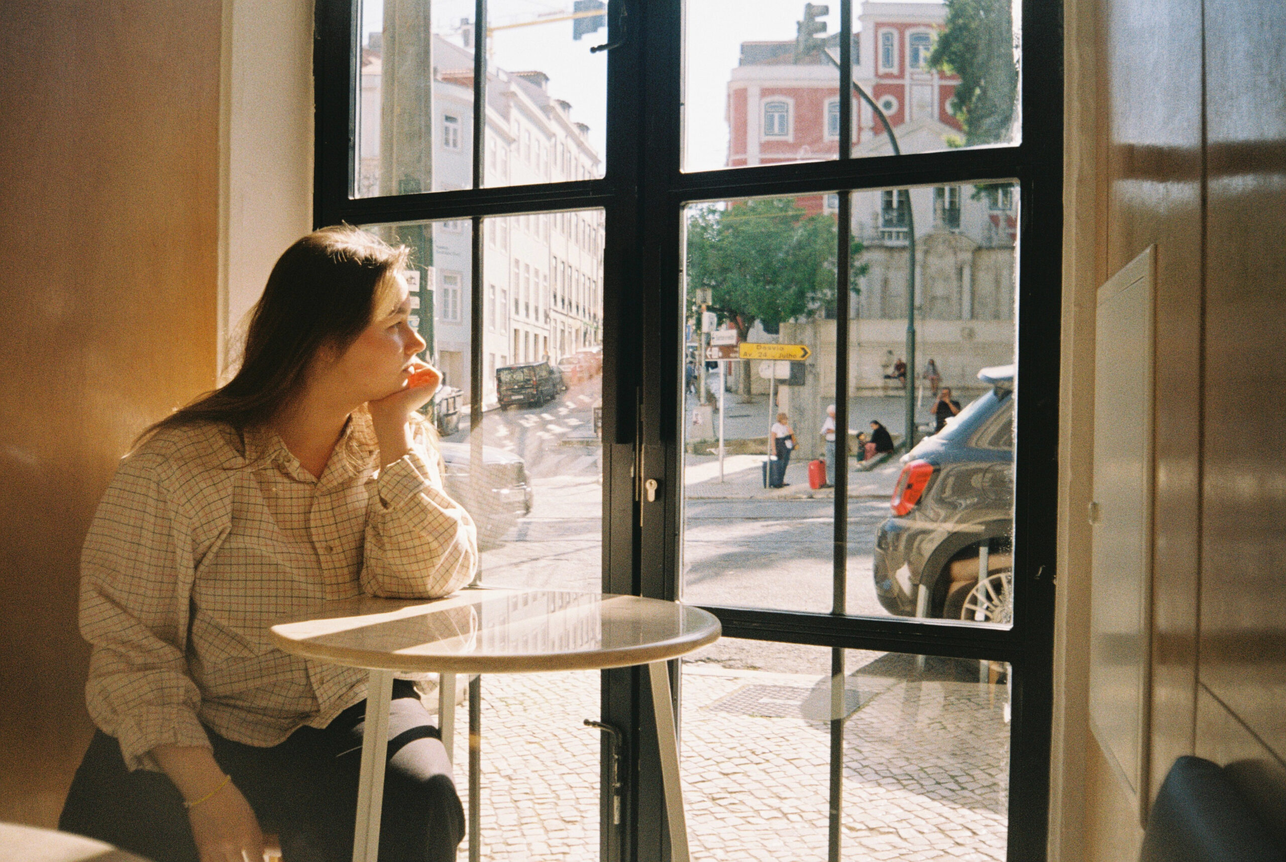 Woman sitting alone overthinking and trying to look for confidence for herself in Manhattan