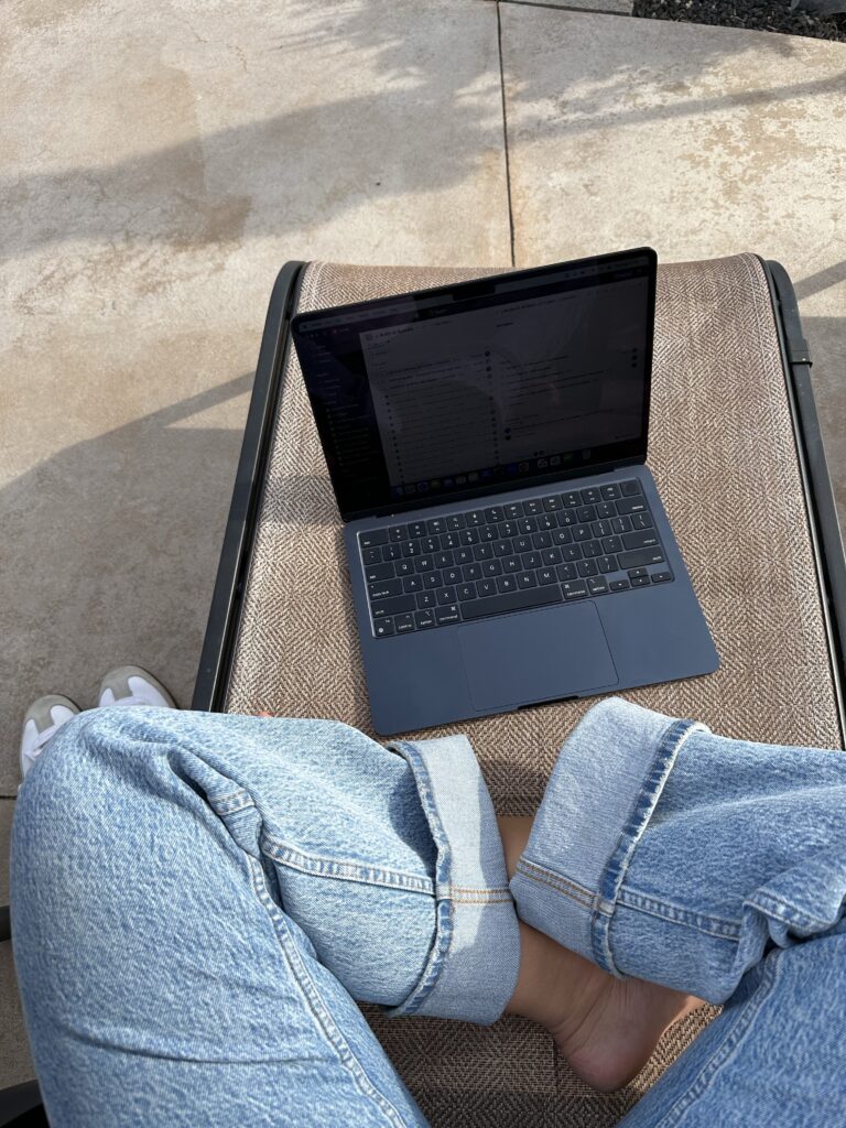 Girl sitting outside with her laptop in Brooklyn