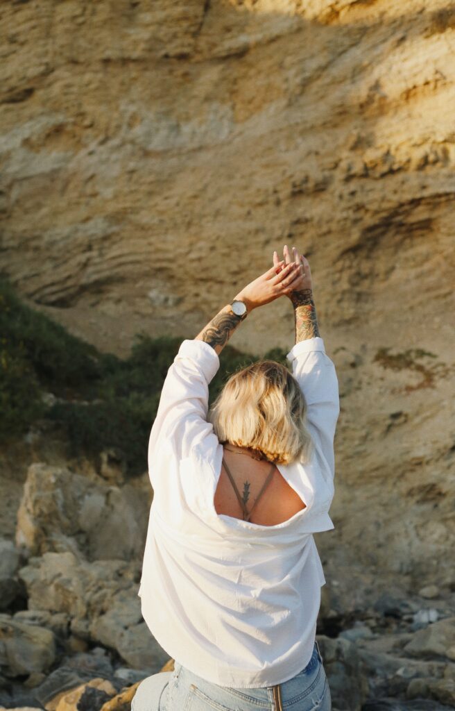 Woman stretching out her arms freely loving herself in Brooklyn