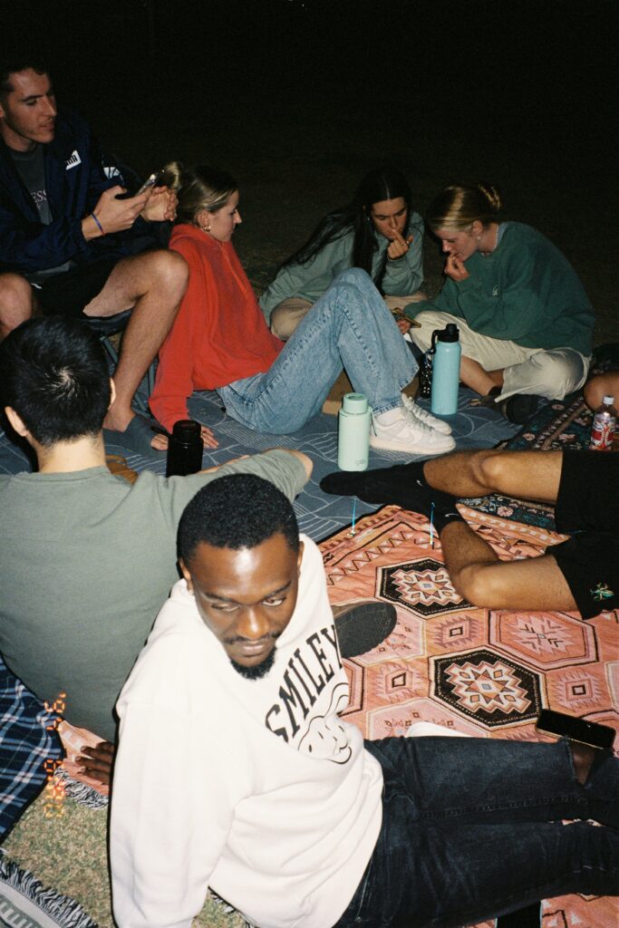 Group of friends hanging outside having a picnic at night in Manhattan