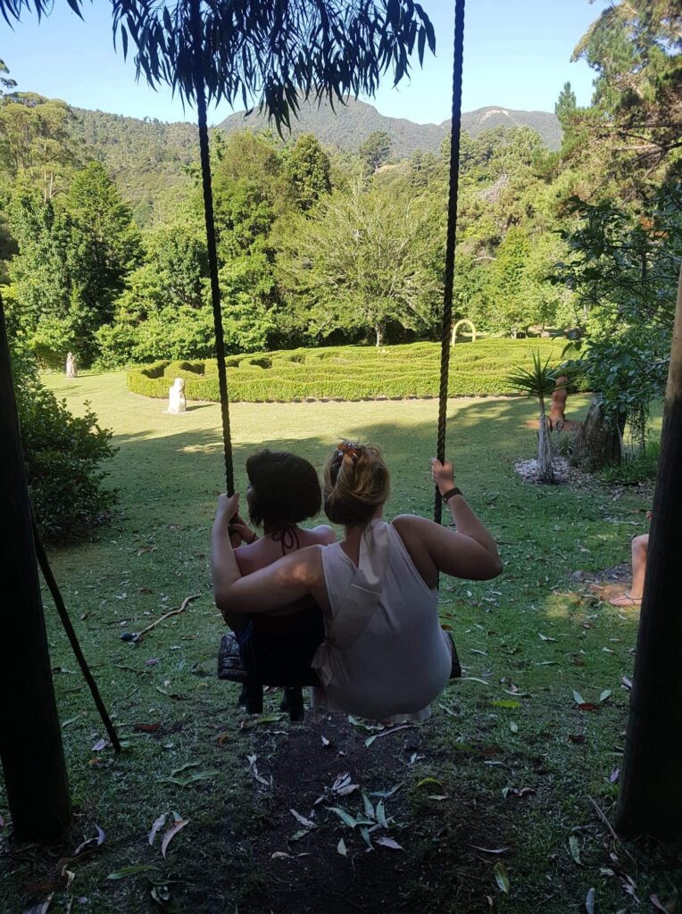 Mother and daughter having a bonding moment outside sitting on a swing in Manhattan