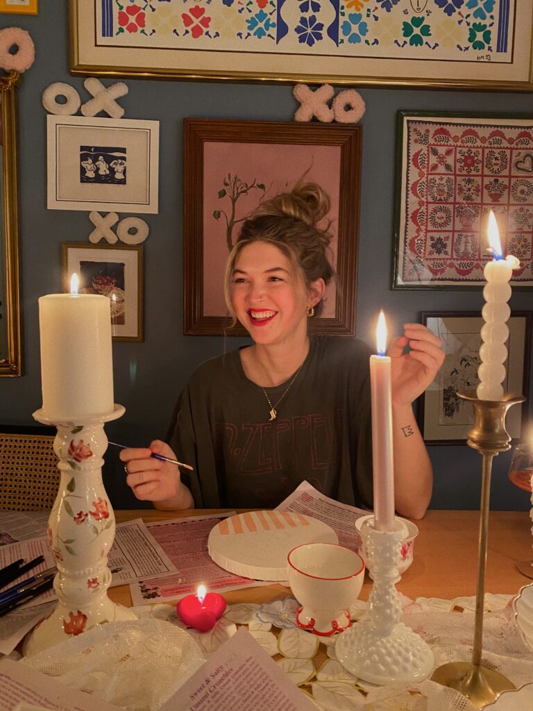 Woman smiling widely while painting in Manhattan
