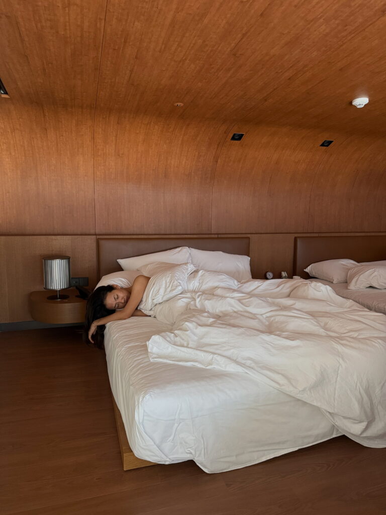 A woman lying down on her bed trying to sleep in New York