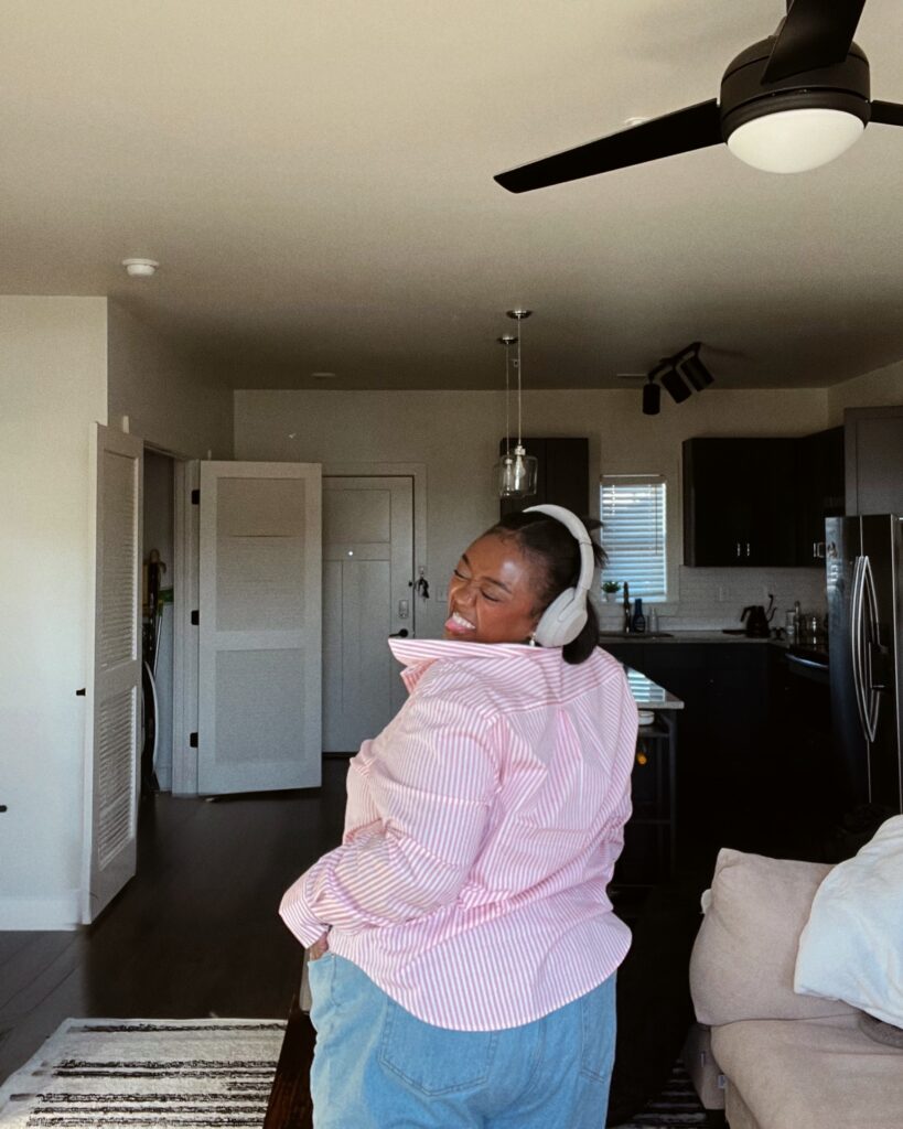 Woman smiling widely and confidently accepting herself in Brooklyn