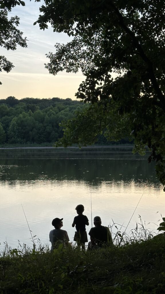 Family taking a breath and sitting by the lake enjoying the view at New York