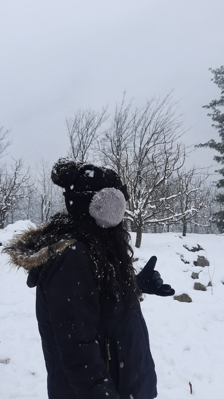 Woman standing outside while snowing at Manhattan