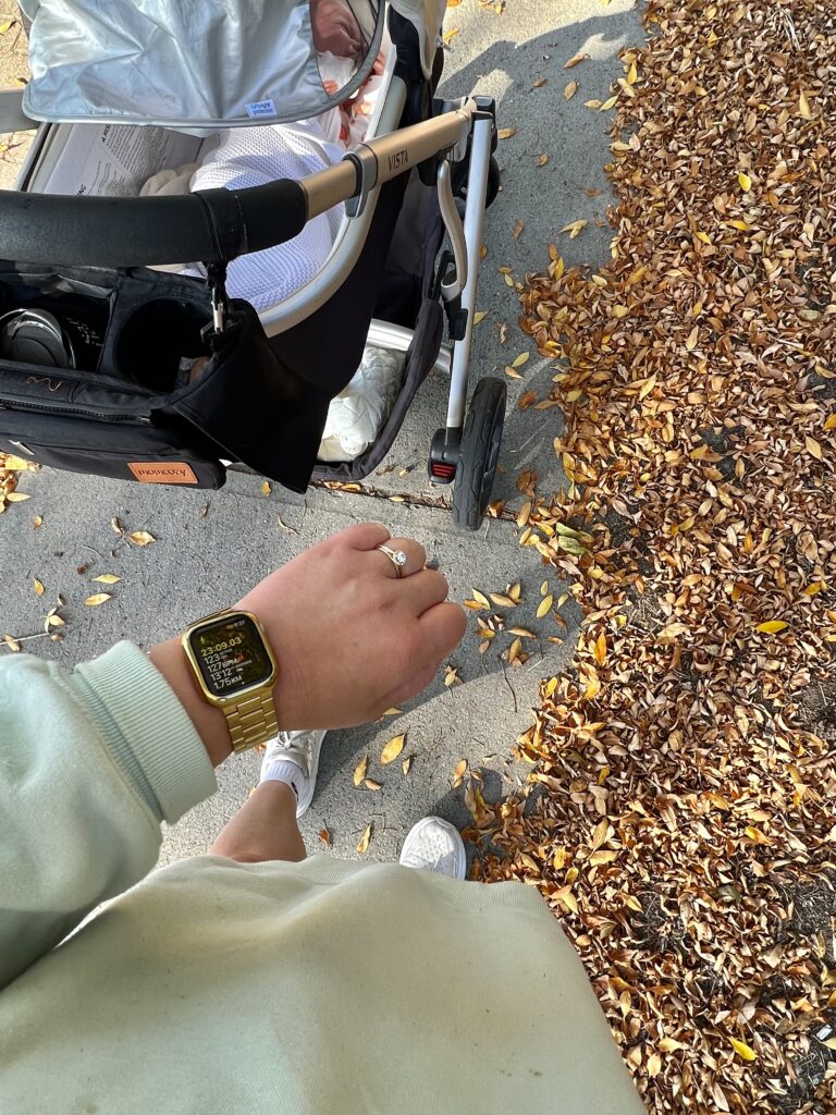Mother with her baby taking a walk while checking the time at Manhattan