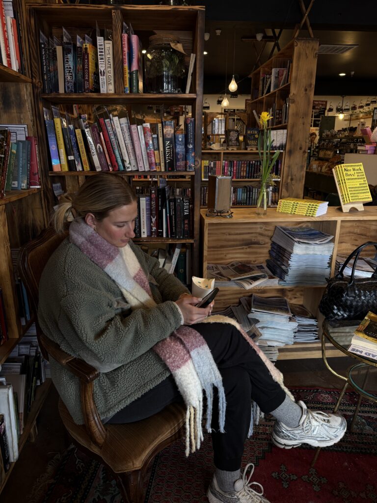 Girl scrolling through her social media in the library in Brooklyn
