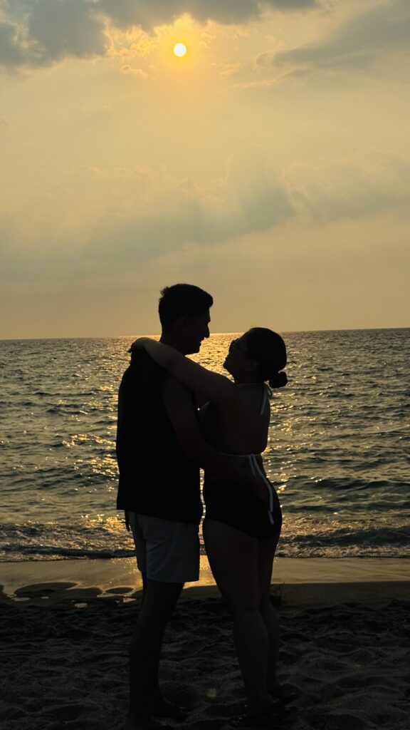 Couple embracing and feeling the sunset at the beach in New York