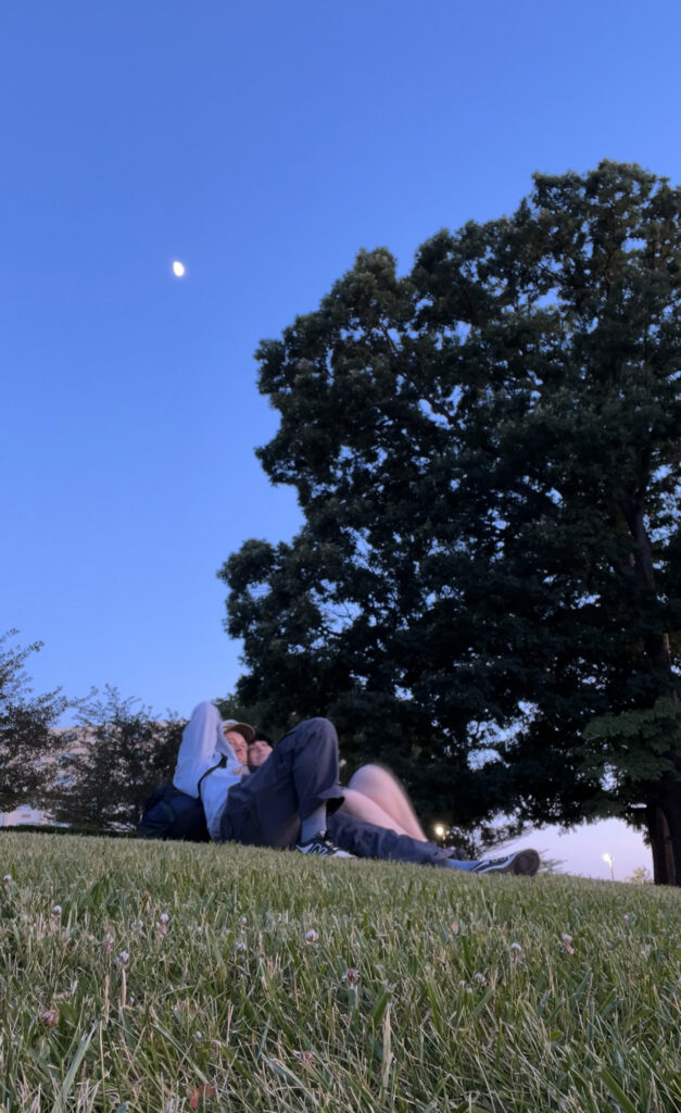 Couple lying down on the grass enjoying each other's company at New York