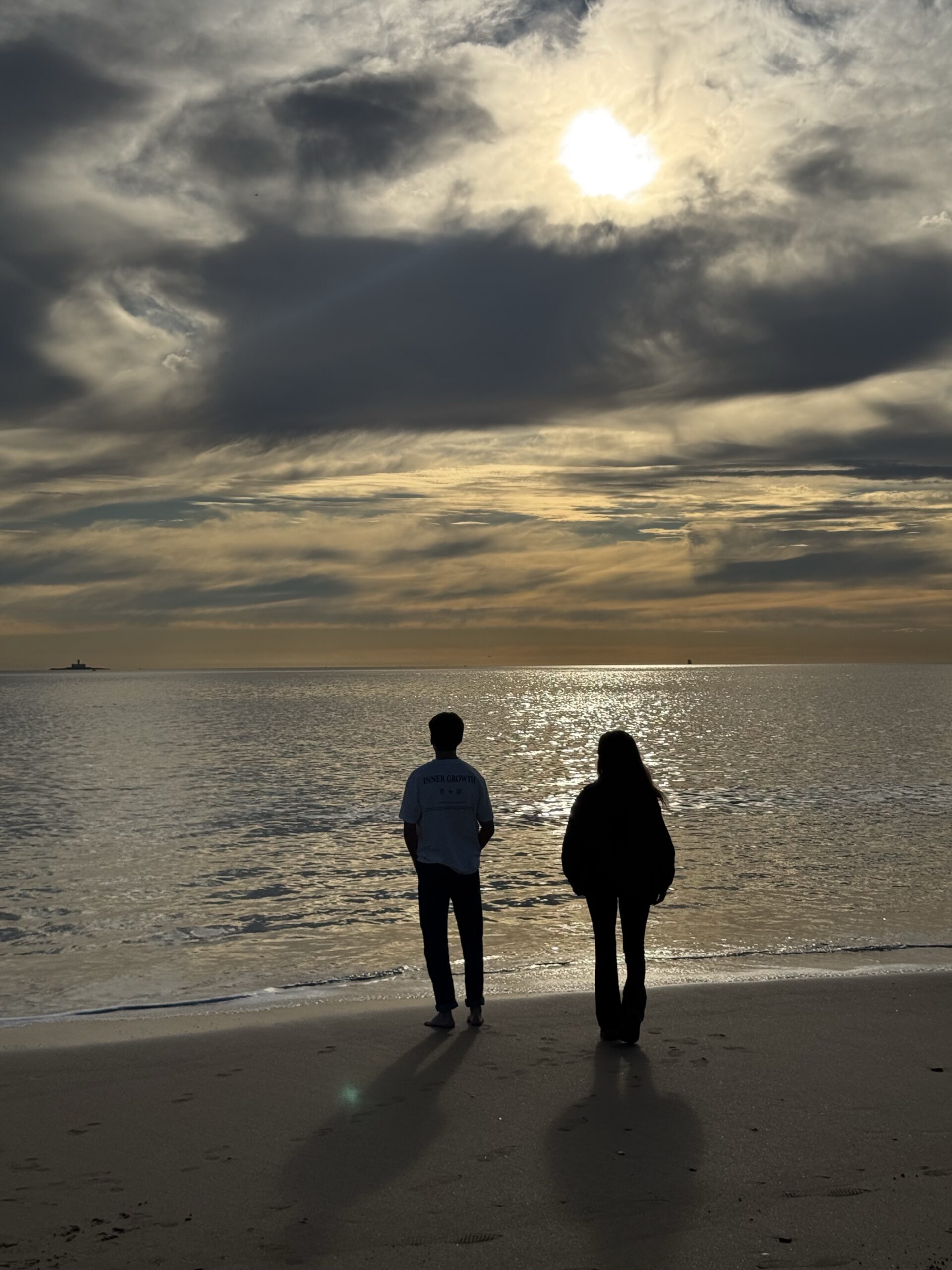 Couple standing in the beach being less affectionate to each other at Brooklyn