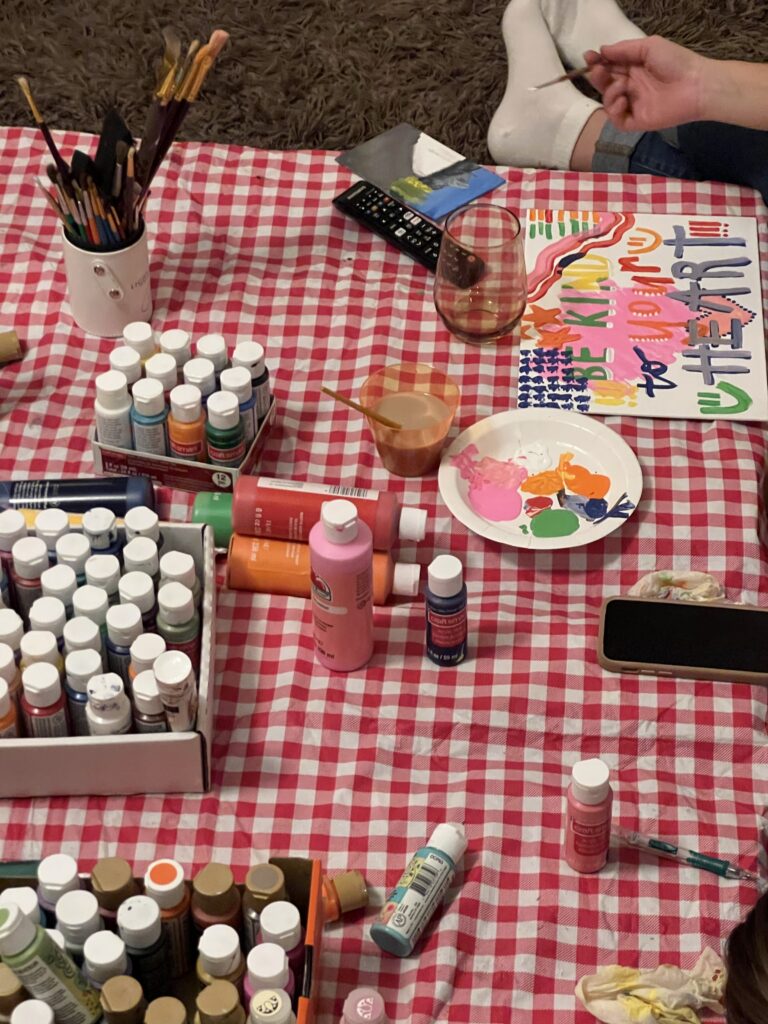 Girl bonding and painting with her friends to keep her mind at peace in Brooklyn