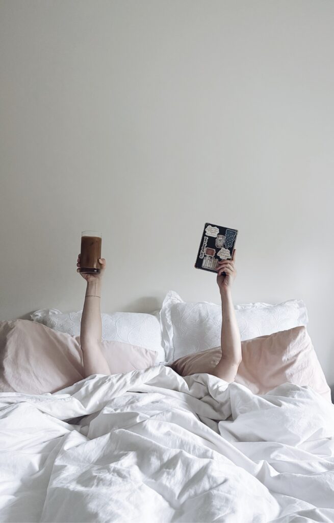 Girl trying to relax by having a cold drink and reading her favorite book at New York