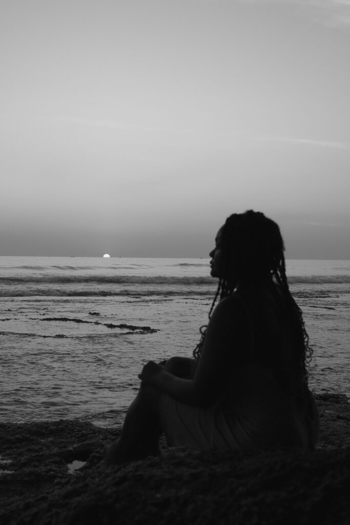 Woman overthinking and feeling empty while looking at the beach at New York