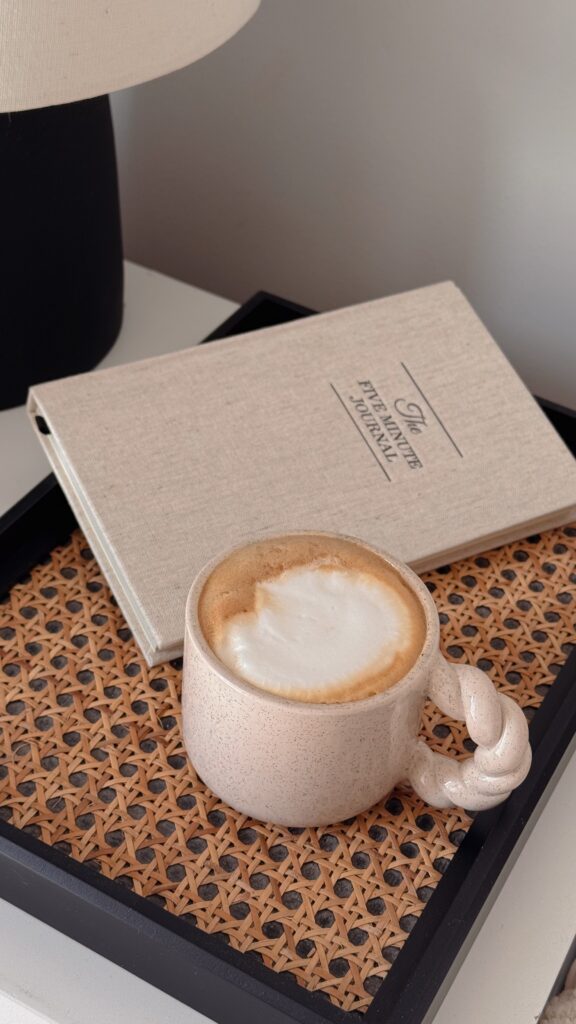 A journal and a fresh cup of coffee for self-care at Brooklyn