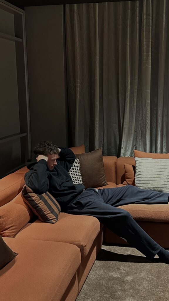 Man sitting in a couch overthinking and having a headache at New York City