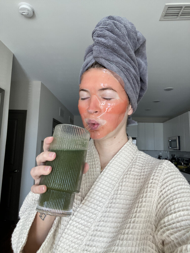 Woman getting her well deserve rest by applying skin care and drinking her favorite beverage at Brooklyn