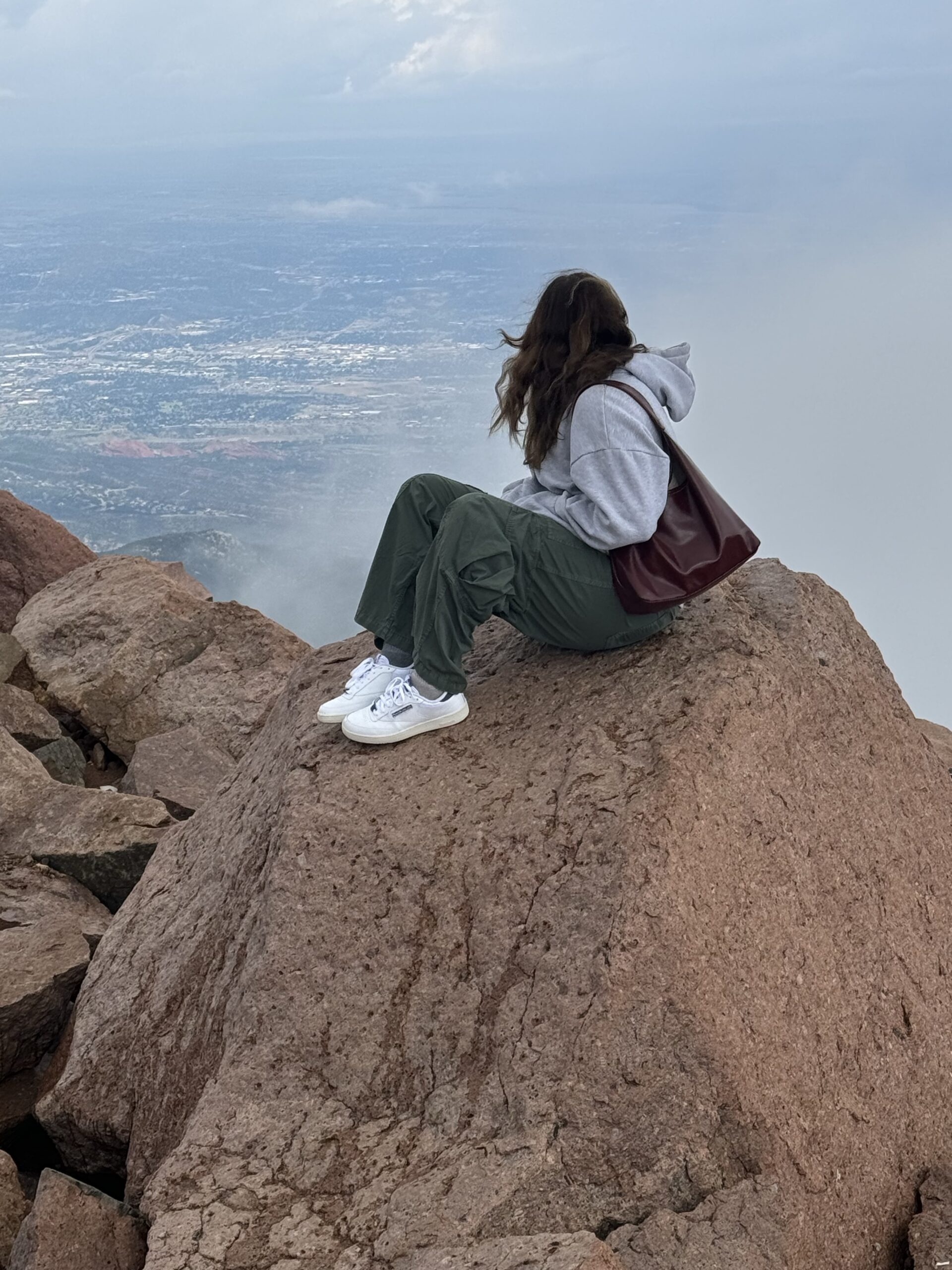 Woman feeling empty after climbing her goal mountain at Manhattan
