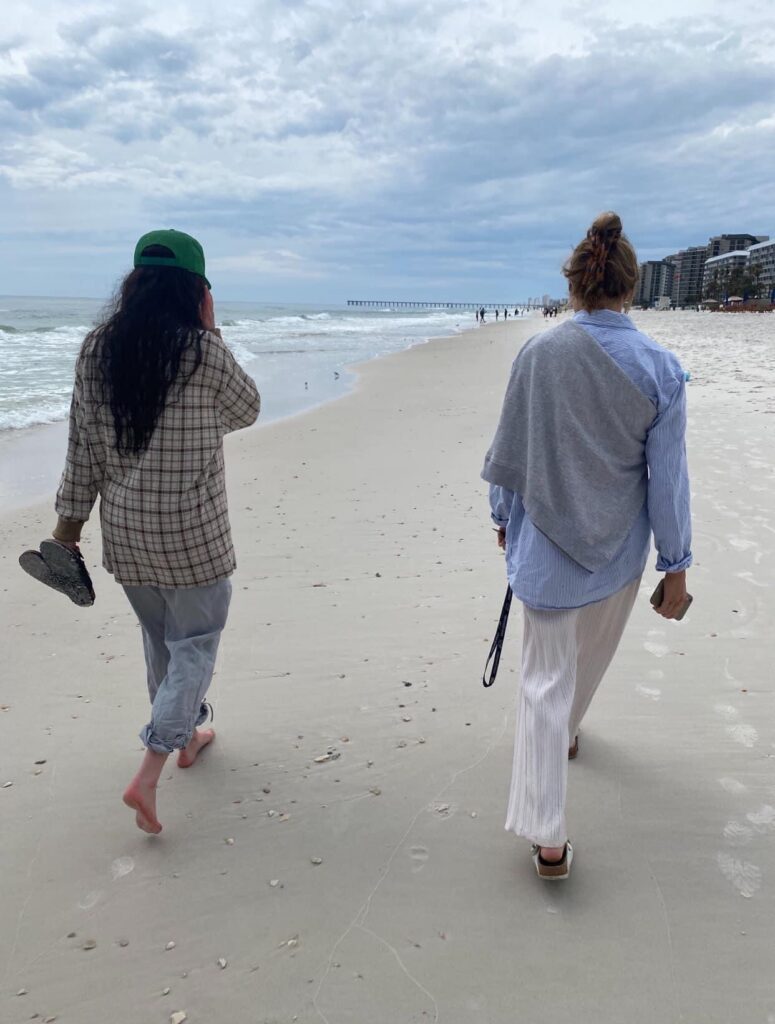 Couple walking apart and not talking to each other because of a fight by the beach at Manhattan