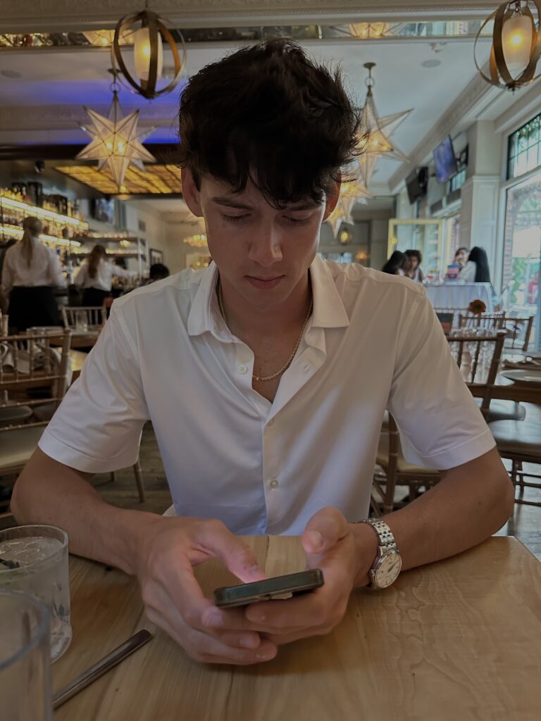 A boy avoiding and scrolling through his cellphone while on a date at Brooklyn