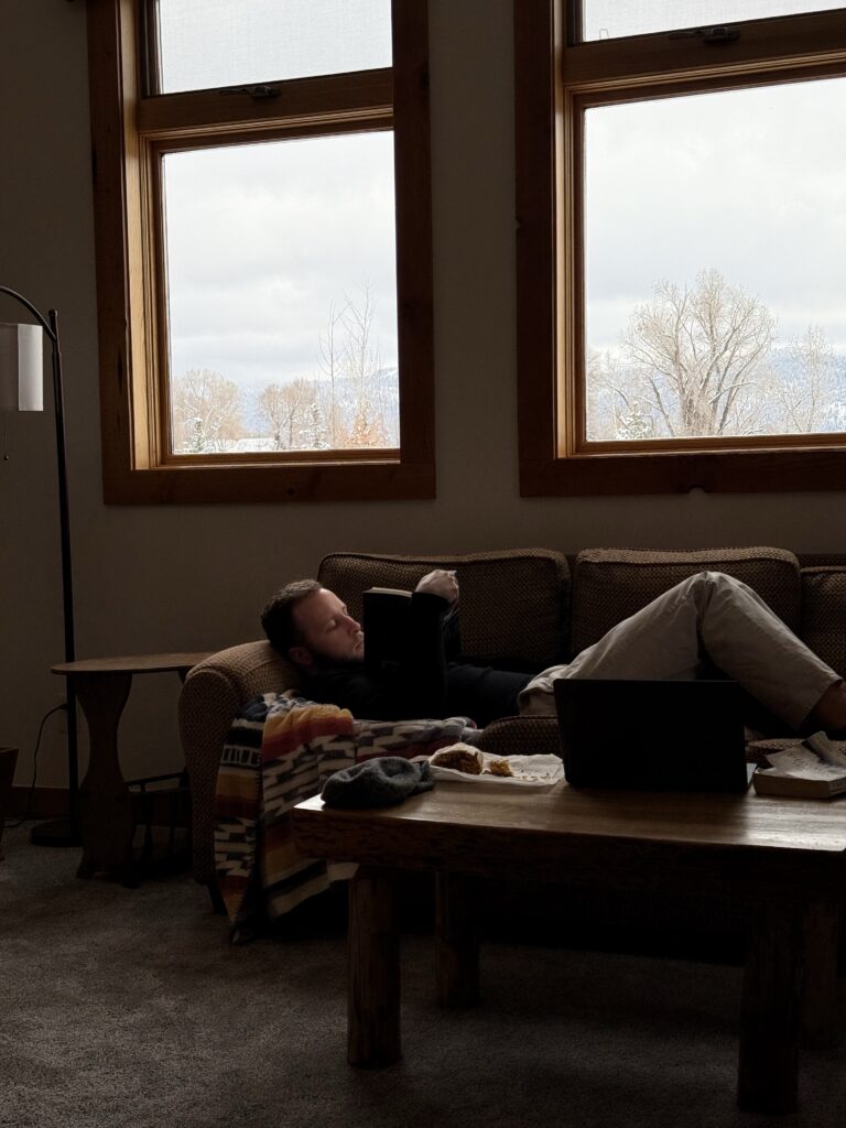 Man avoiding rest and reading a book instead at Brooklyn