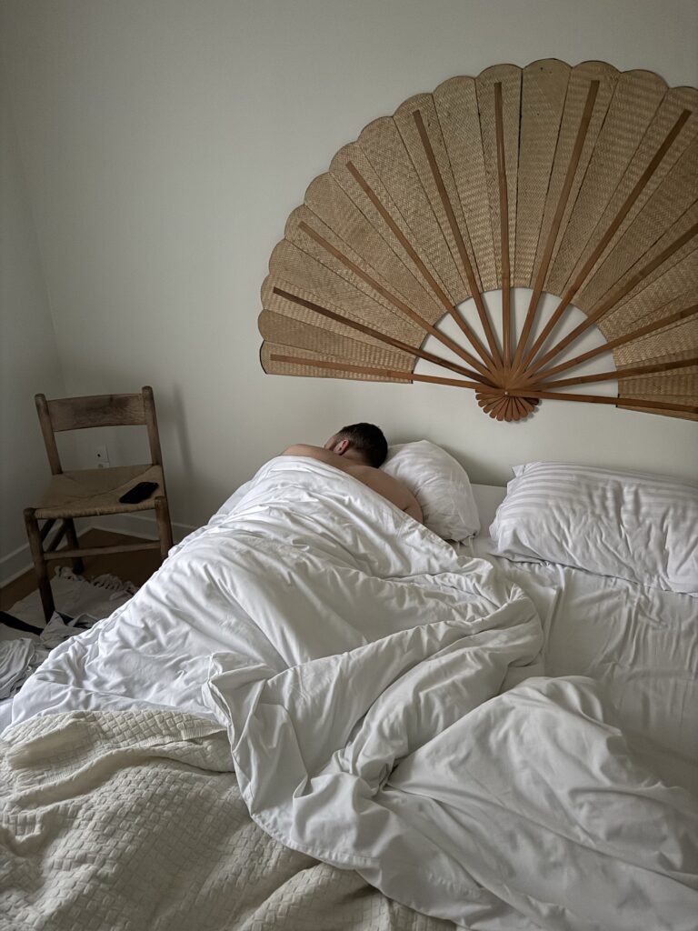 Man lying down feeling burnout at New York
