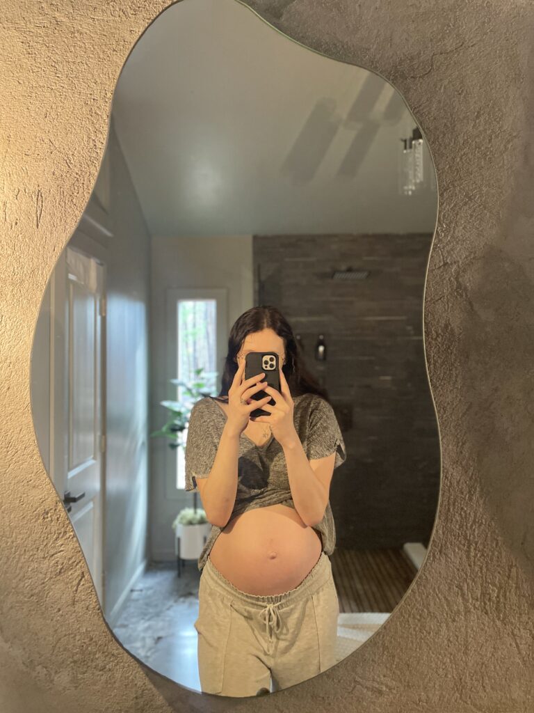 New mom loving herself while looking in the mirror at New York