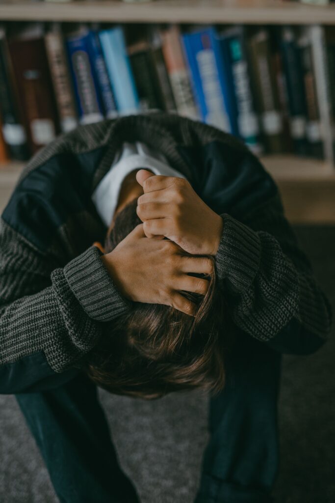 College student at the library overthinking his relationship and avoiding his partner at Brooklyn
