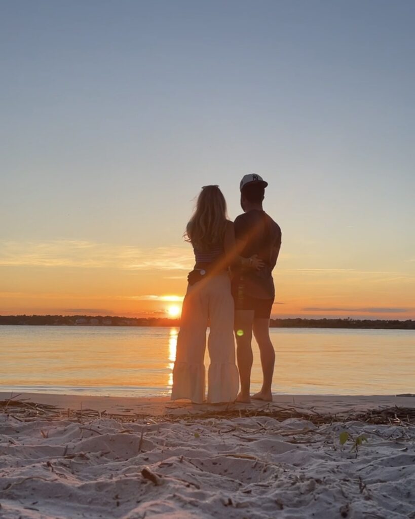 Couple embracing at the beach being honest with their feelings for each other at Manhattan