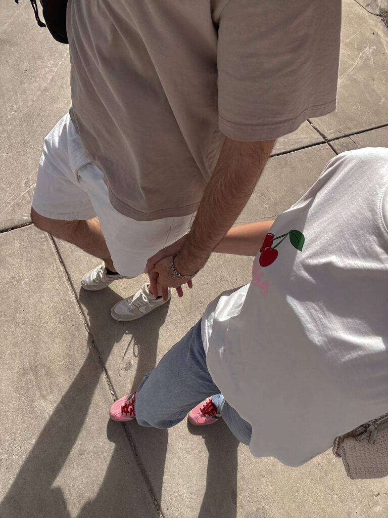 College couple walking around campus while holding hands at New York