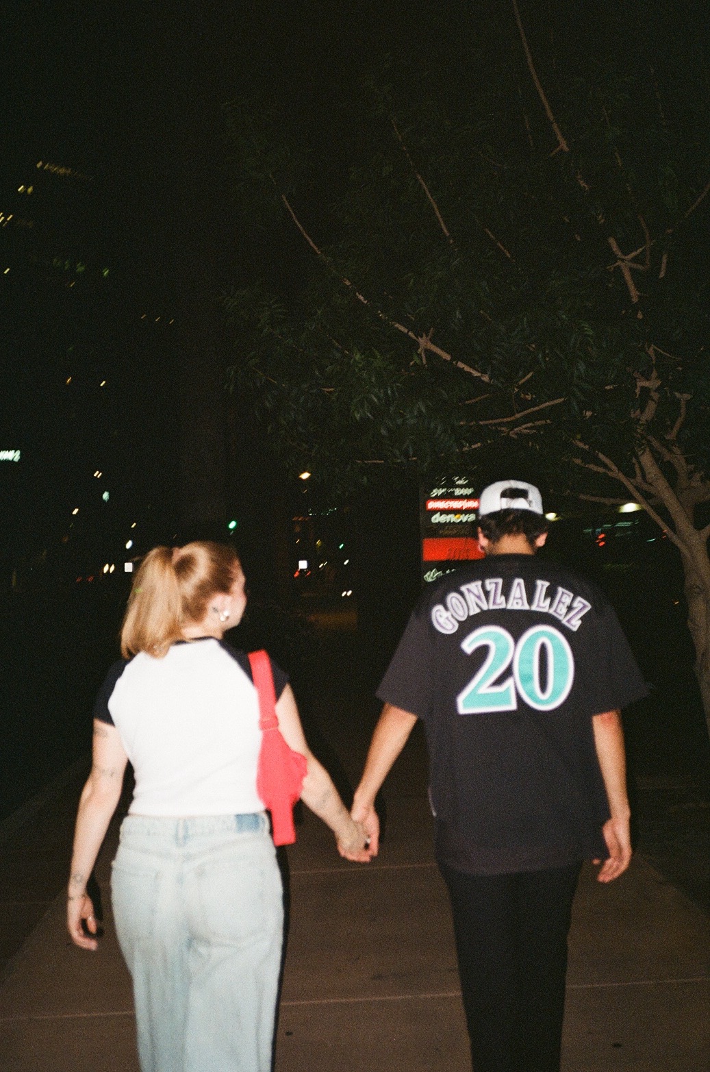Girl admiring her boyfriend while walking and holding his hand at New York