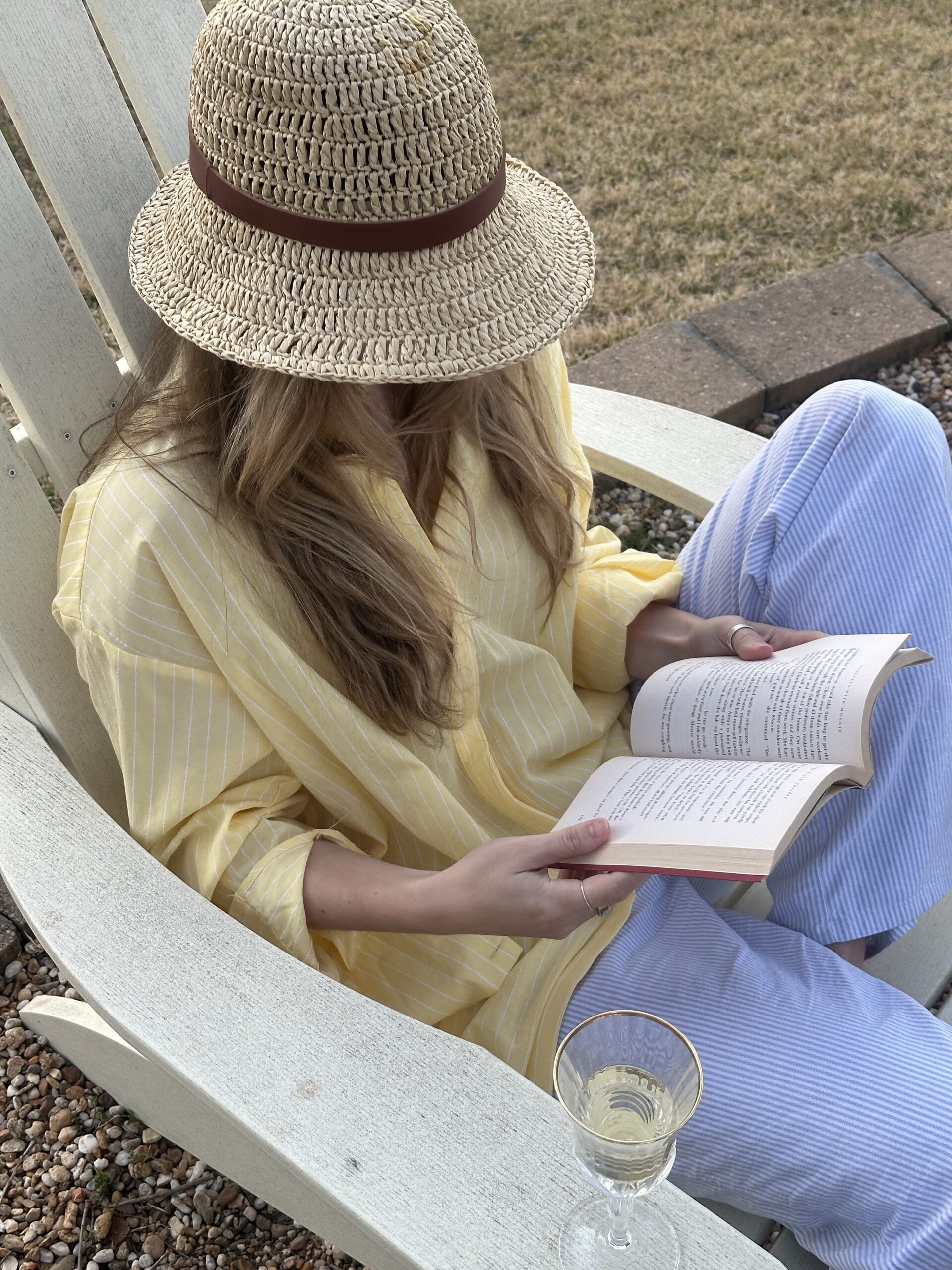 A young woman sitting and reading or simply relaxing outside at Brooklyn