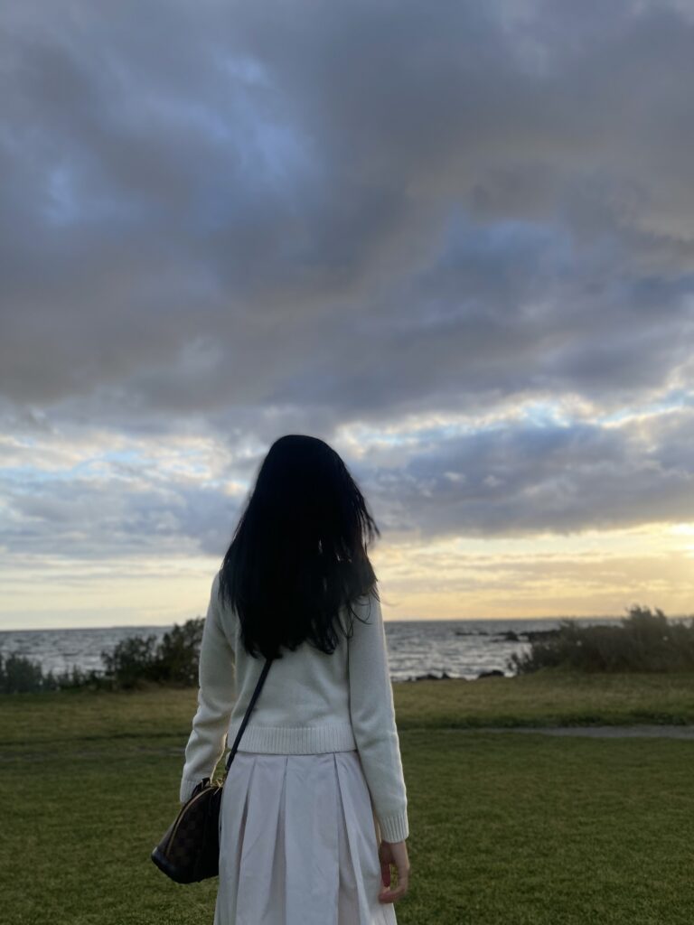 Young woman staring at the view overthinking her relationship alone at Manhattan