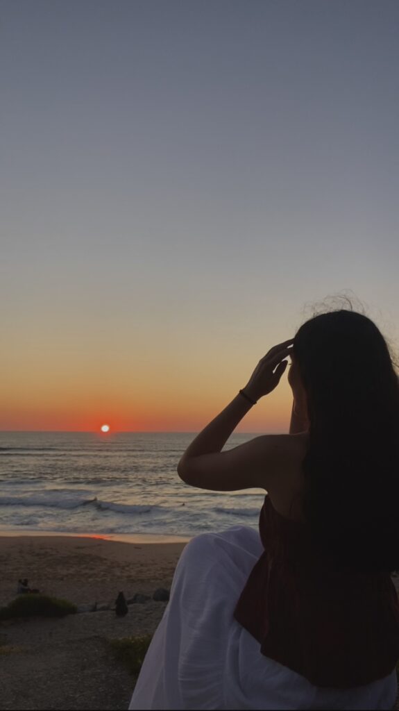 Young adult feeling nostalgic and enjoying her summer alone by the beach at Brooklyn