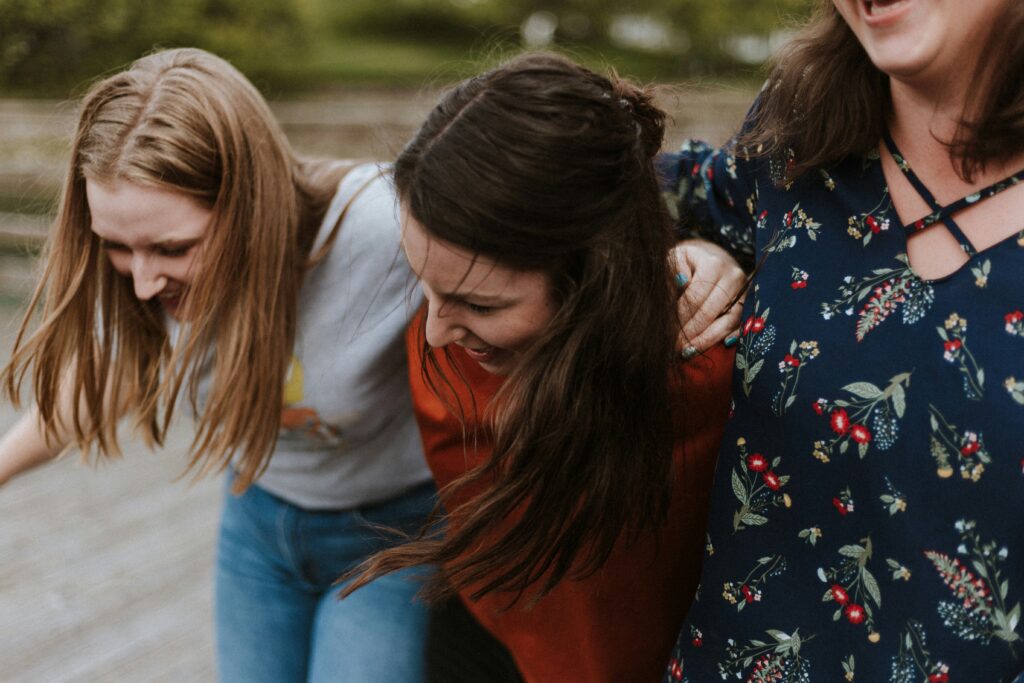 Sorority girls walking while laughing together in the campus at Brooklyn