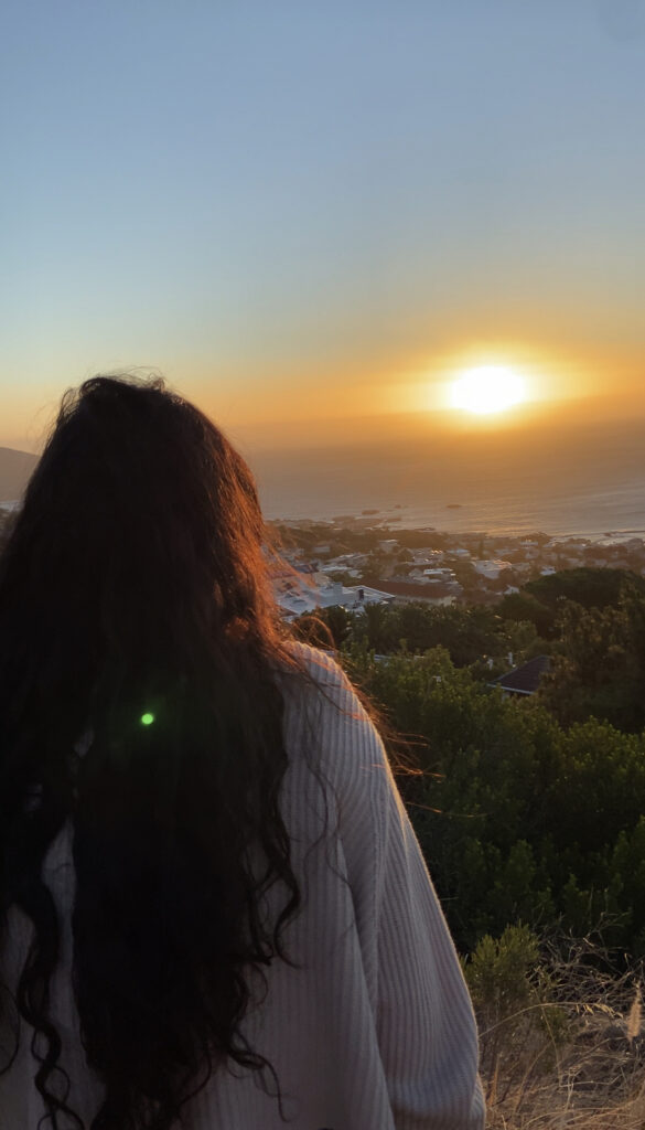 Woman staring at the view while reflecting on herself alone at Manhattan
