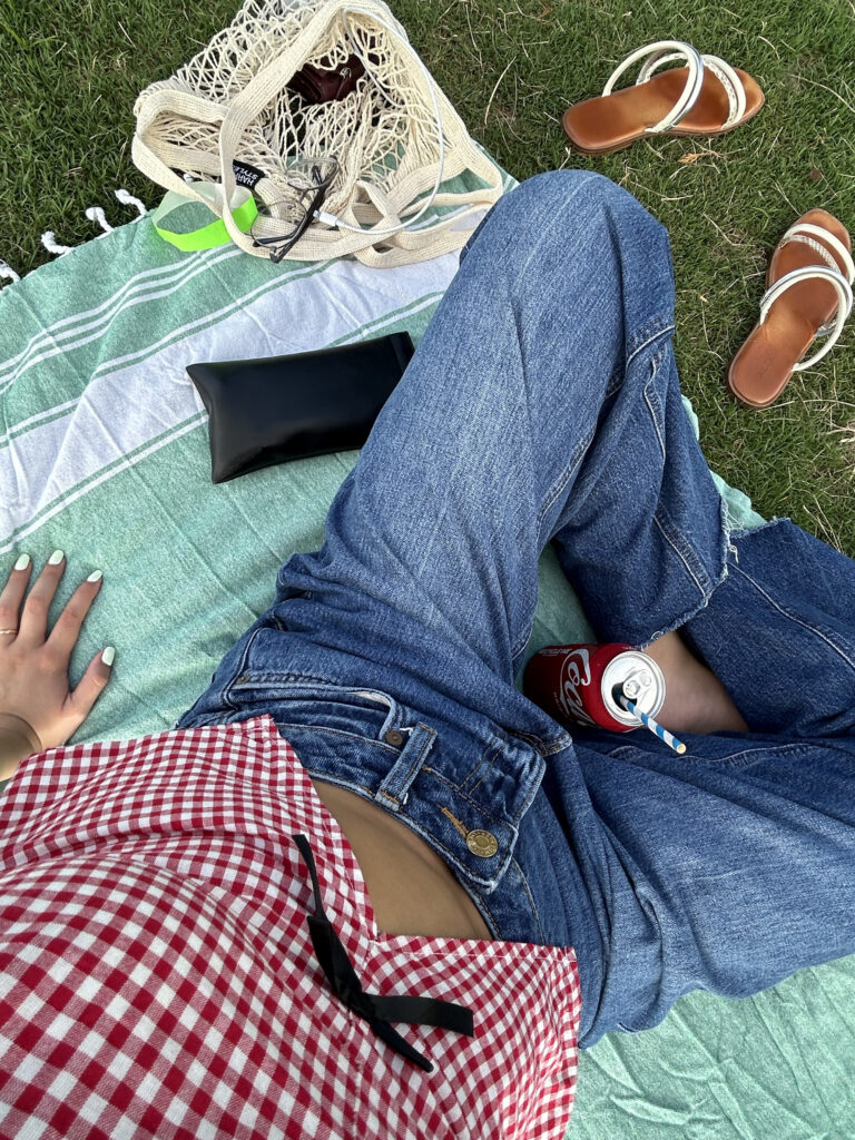 Woman enjoying her time alone having a picnic at the park at Manhattan